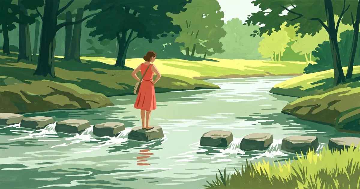 A line of flat stepping stones crossing a shallow stream in summer woodland, with one stone missing from the middle of the line. A woman in a coral red dress stands on the stone just before the gap, hands on her hips, looking across at the far bank.